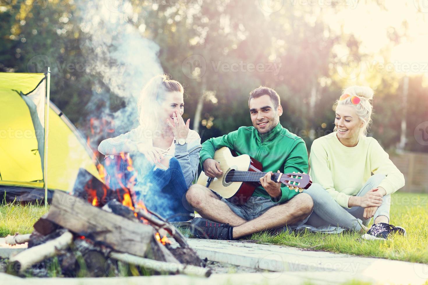 Group of friends having campfire photo