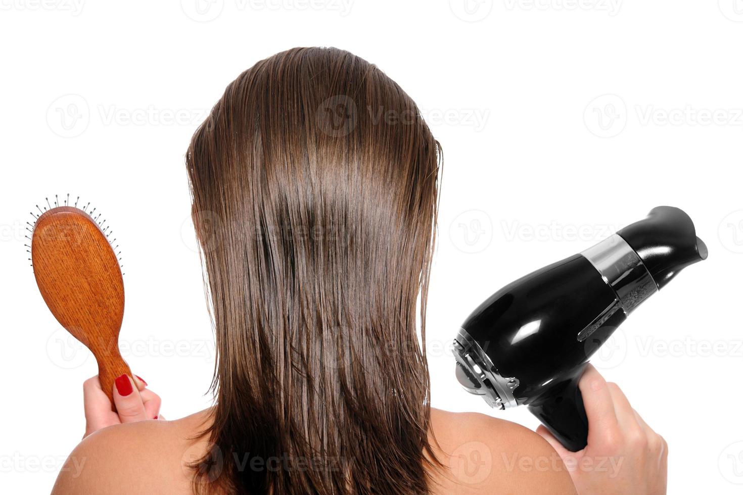 Young woman with a hair dryer and hairbrush photo