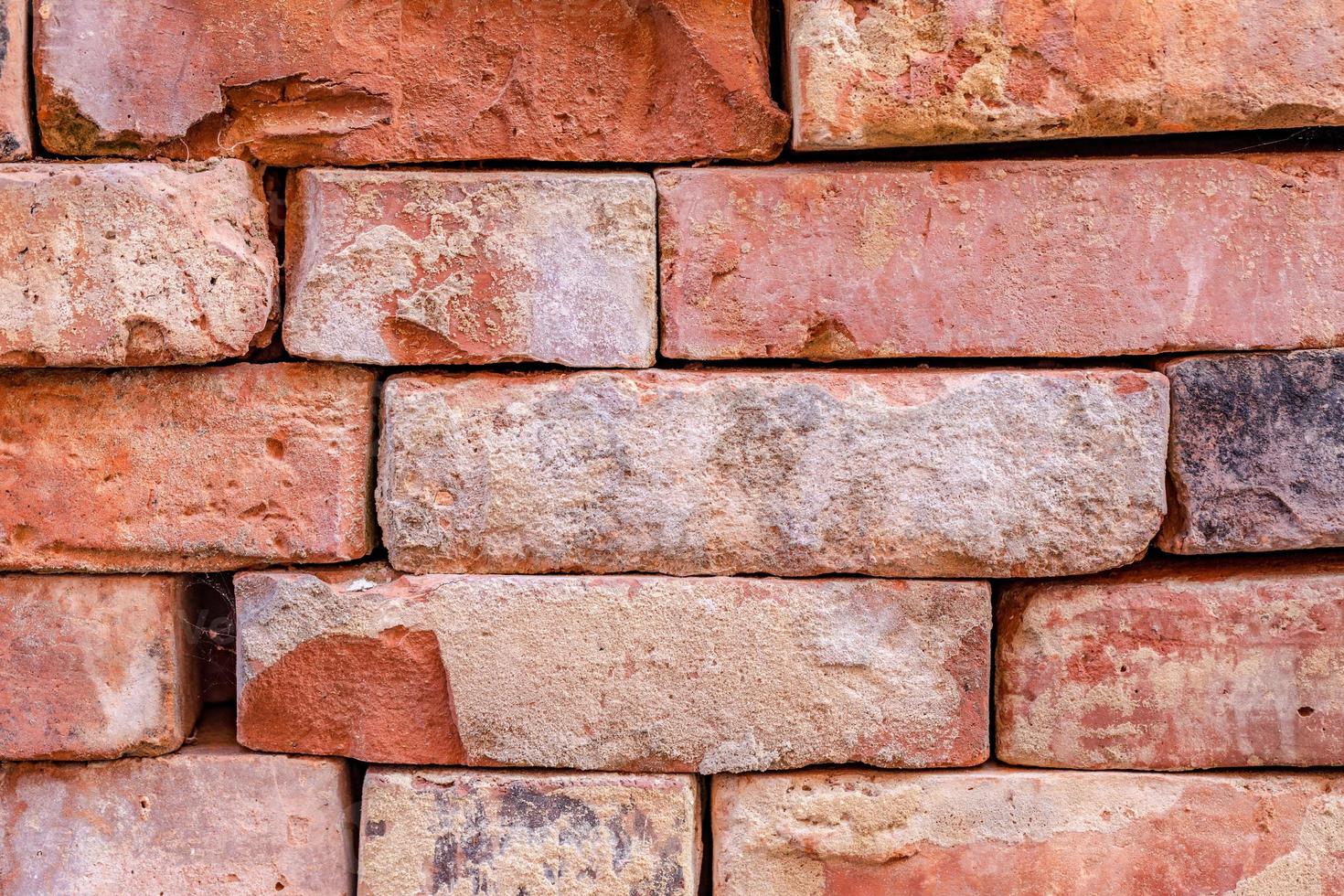 Old cracked brick wall background, pattern design element. Rustic vintage brick closeup texture photo