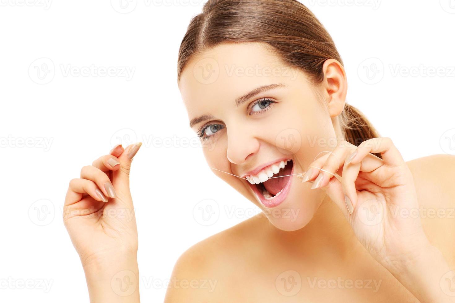 Woman using dental floss photo