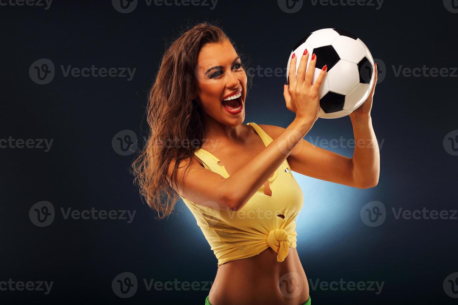 Happy fan cheering with football photo