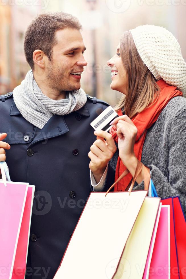 Couple shopping in the city with credit card photo