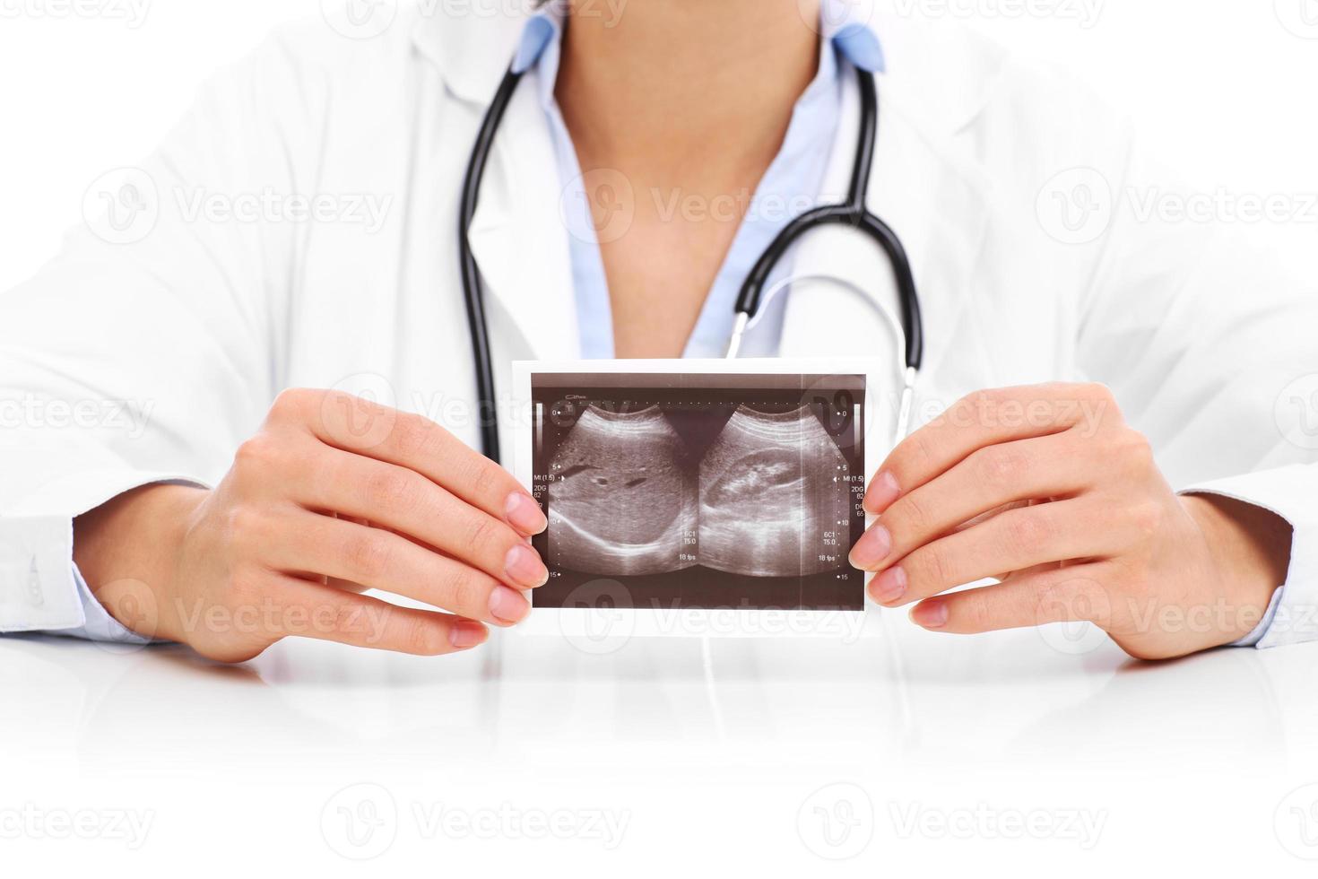 Midsection of woman holding ultrasound photo