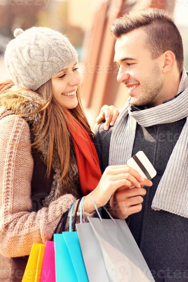 Young couple with credit card shopping in the city photo