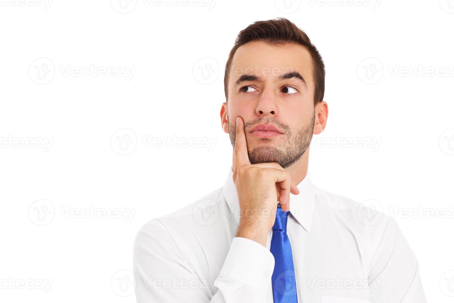 Young businessman thinking over white background photo