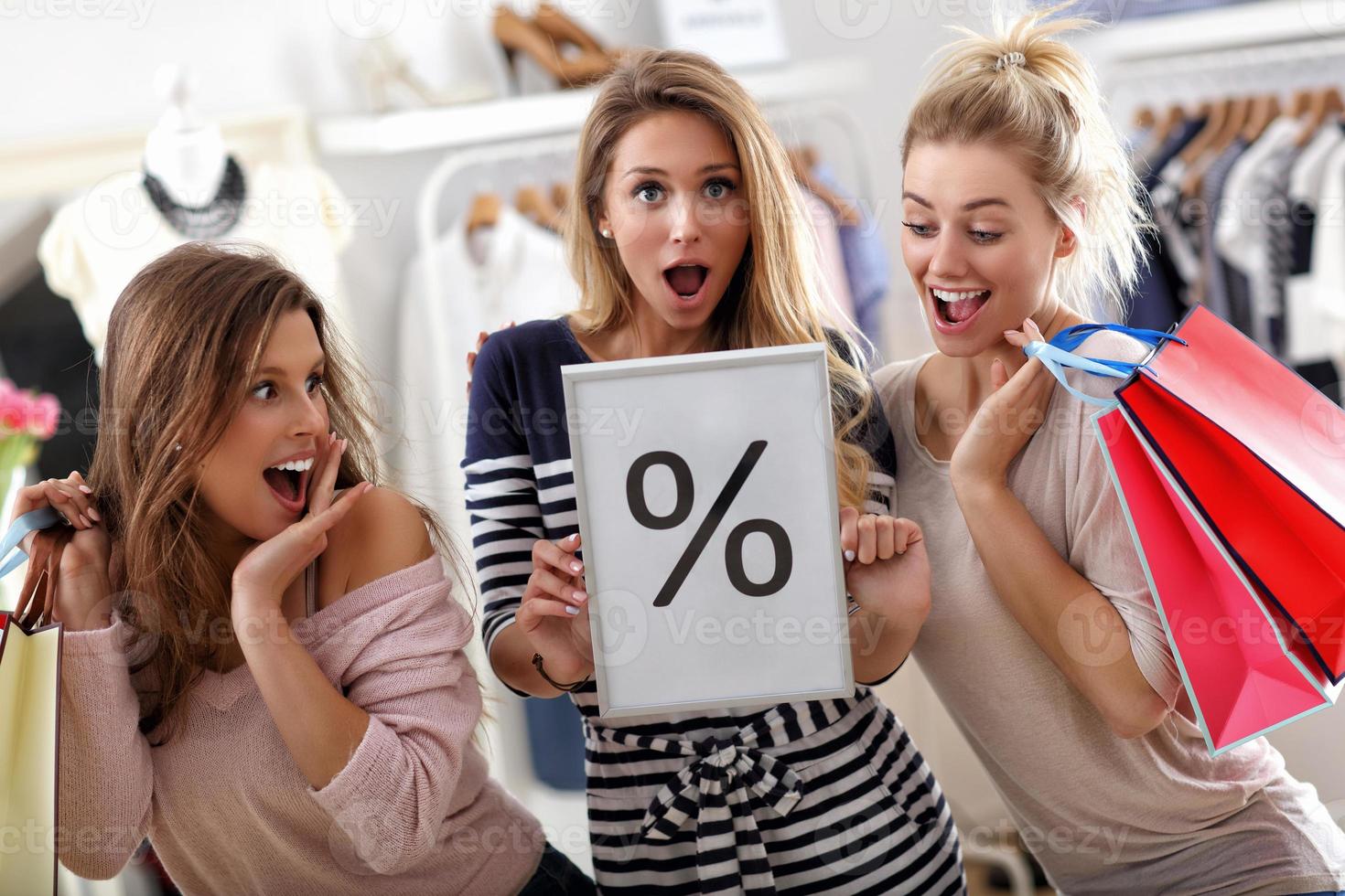 Group of happy friends shopping in store photo
