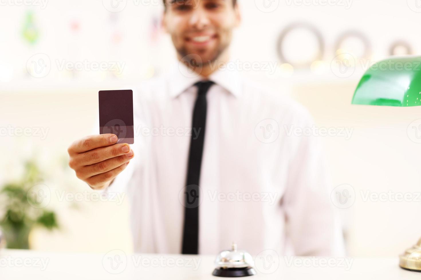 Happy receptionist working in hotel photo