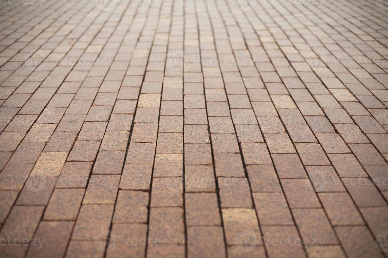 Stonework made of red cobblestones. Details of road. photo