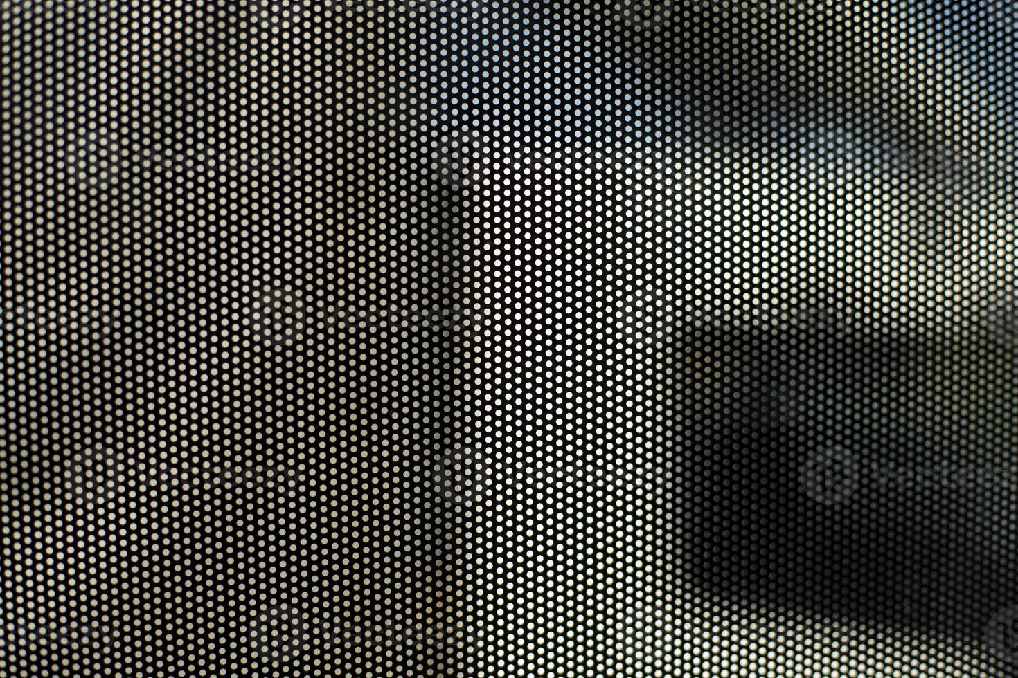 Film on glass of mesh texture. Advertising film from inside interior of bus. photo