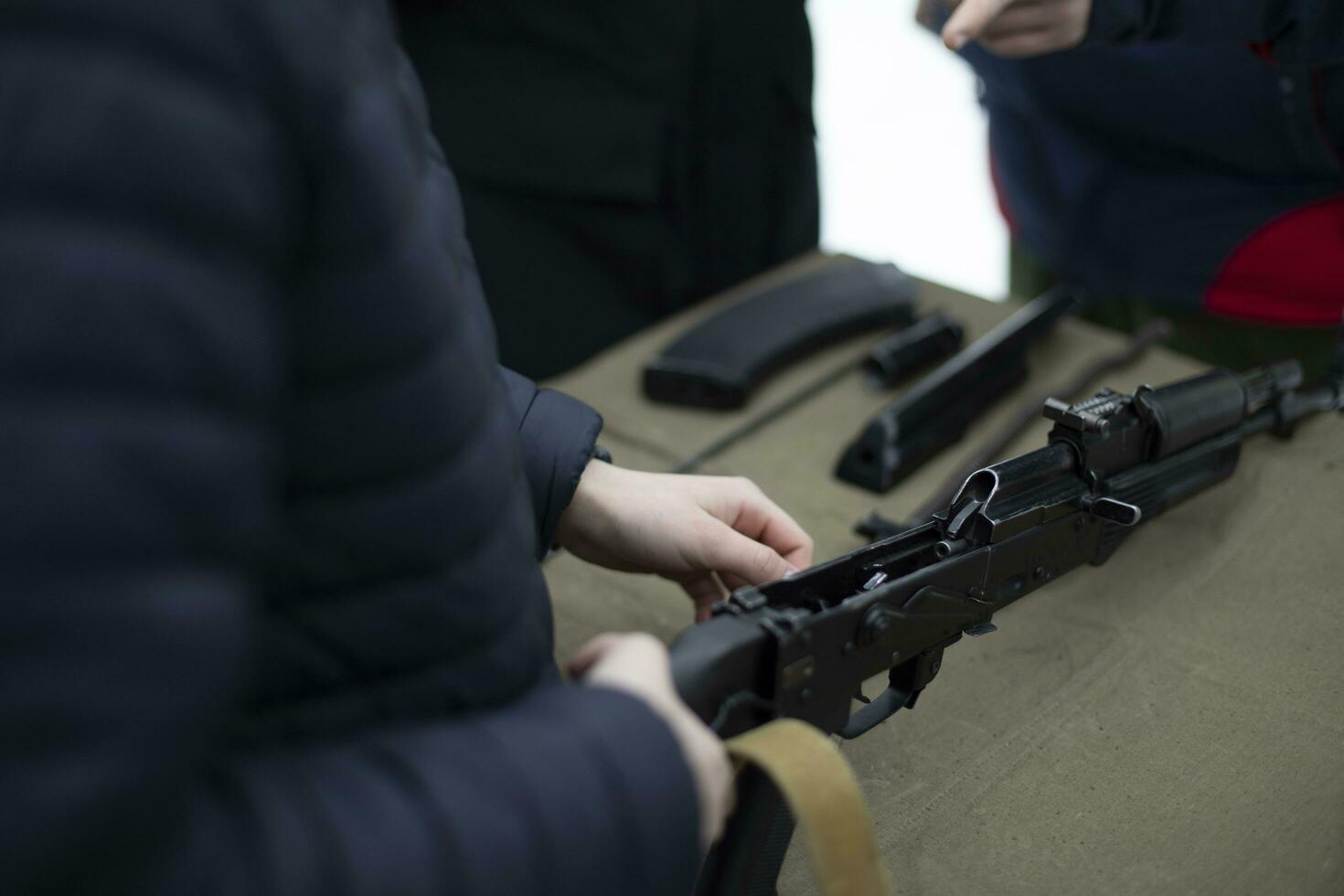 Shooting training. Dismantling of training weapons. Training of volunteers in Russia. Assembly of firearms. photo