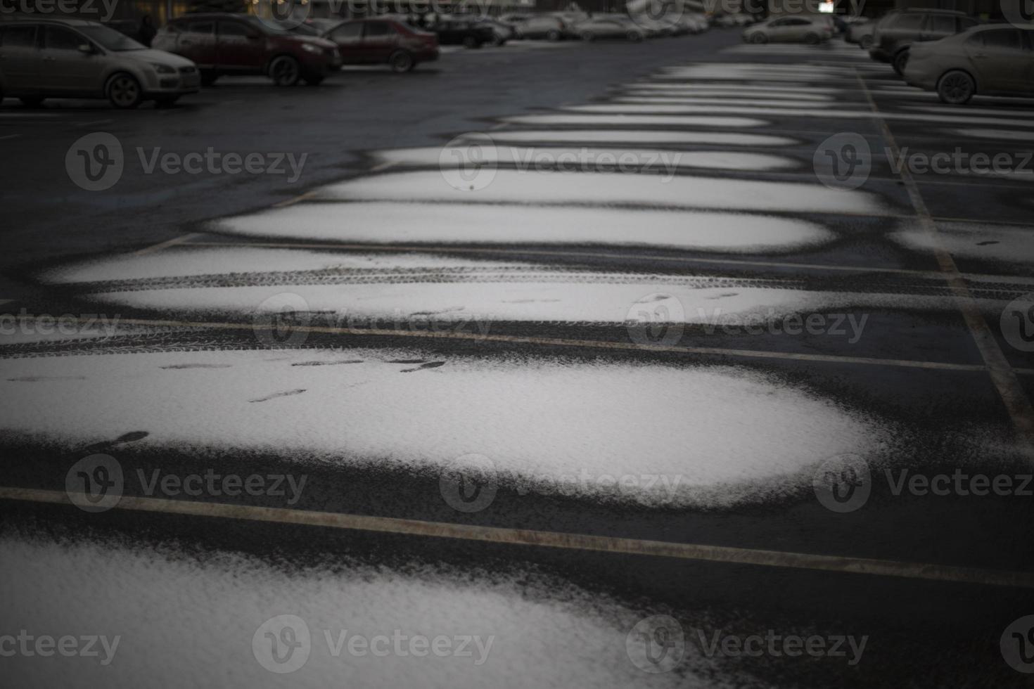 Snow in parking lot. Parking for cars in winter. photo