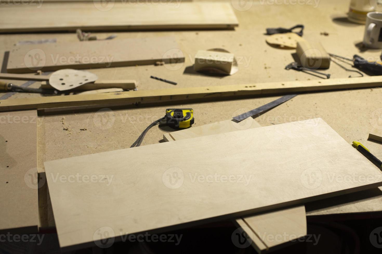 Details of carpentry workshop. Wooden objects on table. Table in workshop. photo