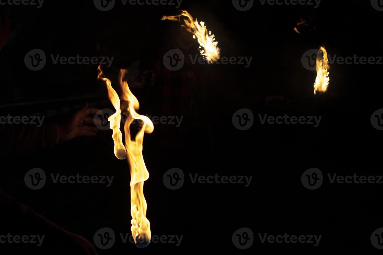 Flames in dark. Burning kerosene. Fire show at festival. photo