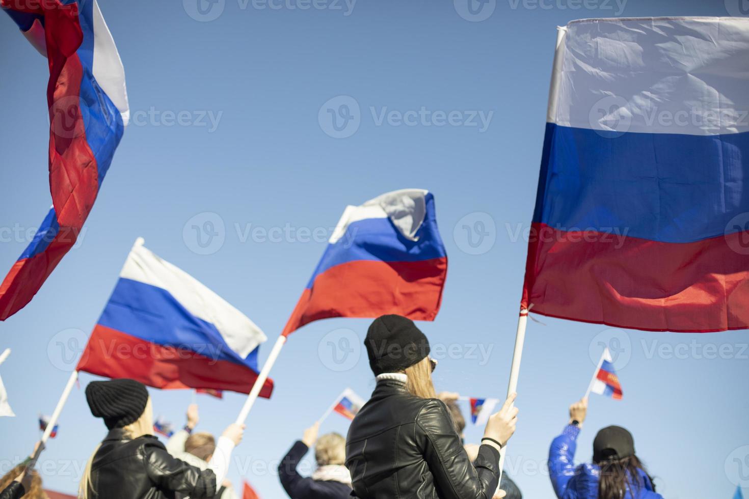 Girl holds flag of Russia. Government rally in Russia. National flag of Russian Federation. photo