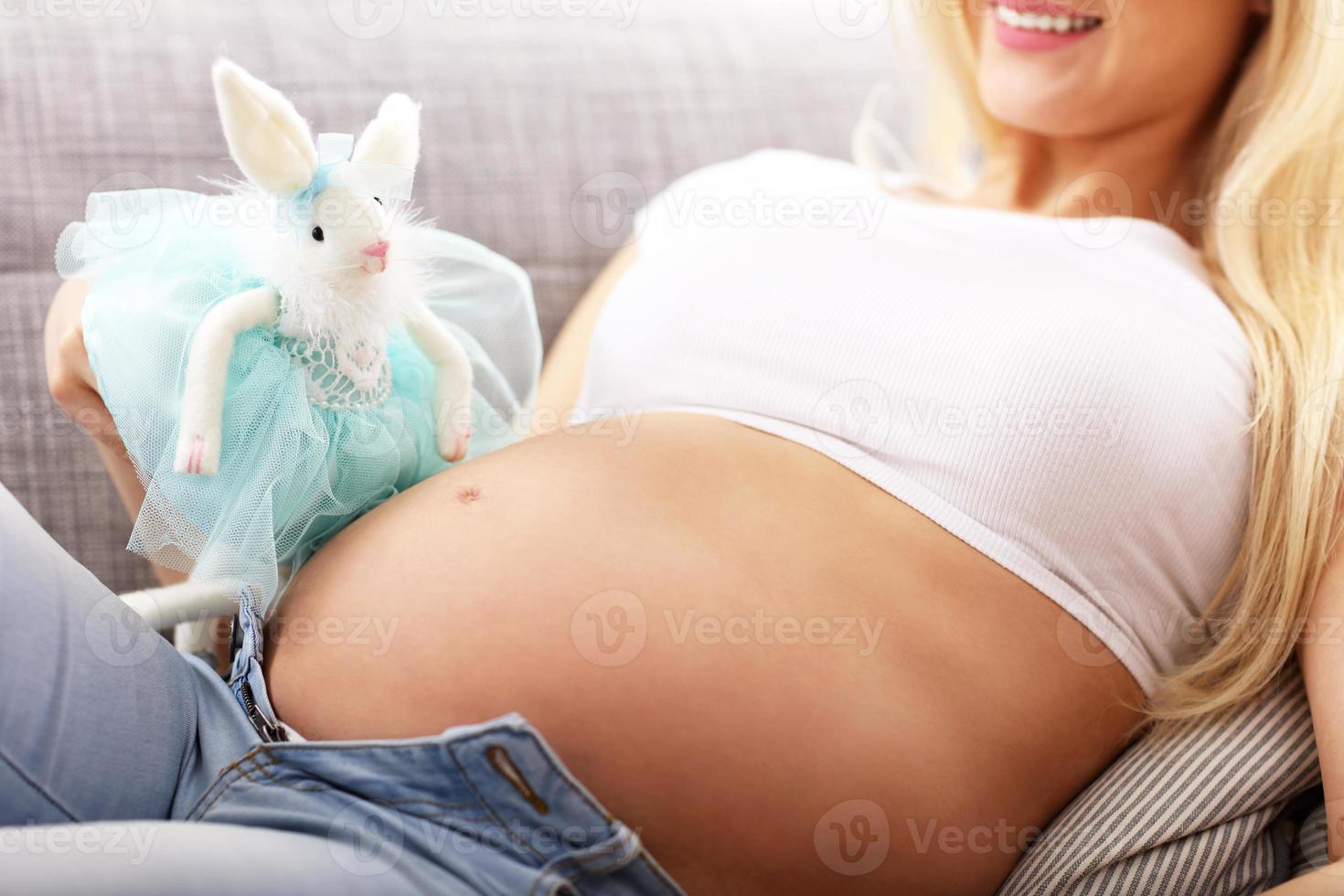 Happy pregnant woman getting presents at baby showe photo