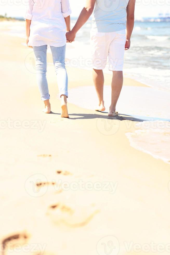 Couple walking at the beach photo