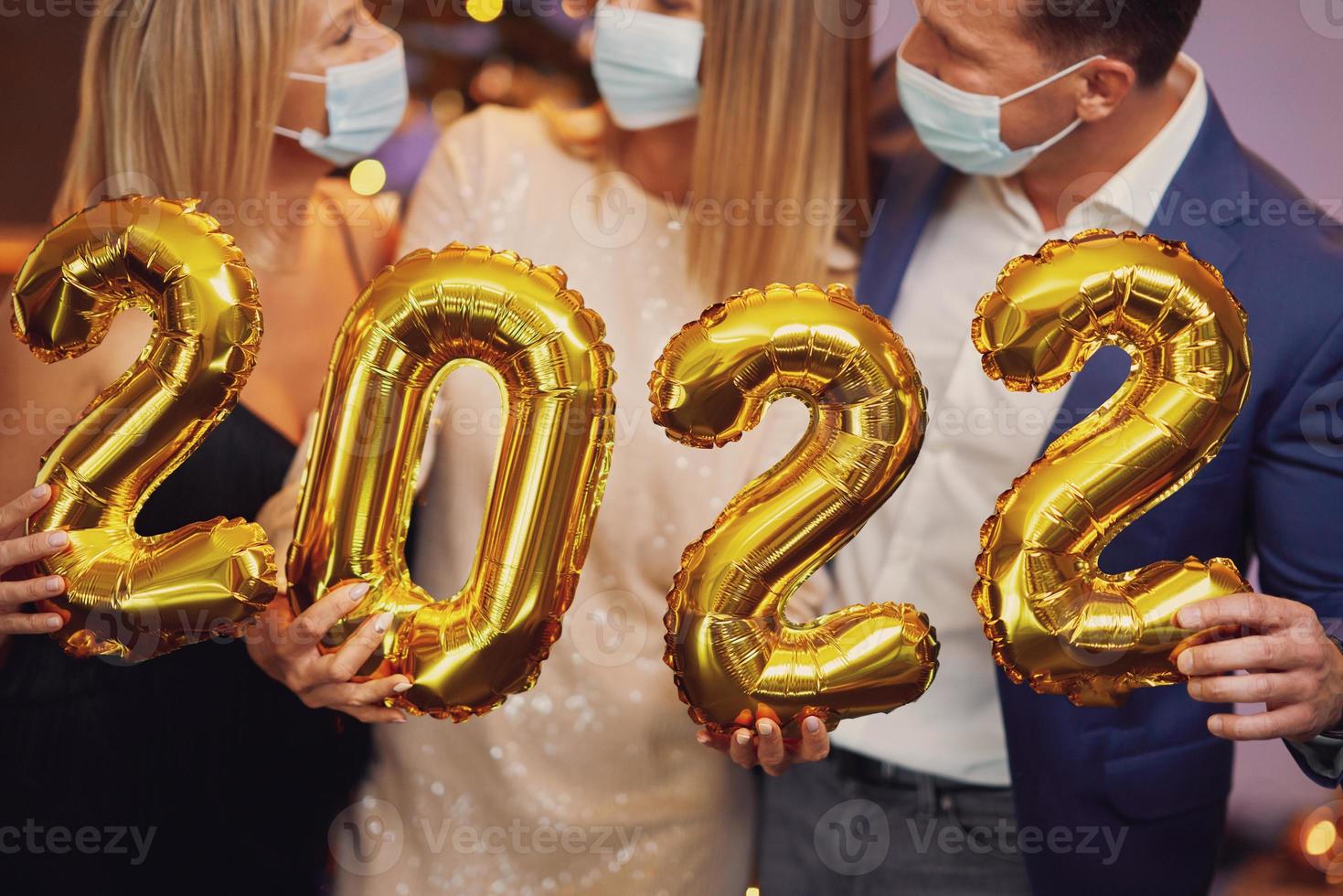 Beautiful young friends having fun at New Year's Eve Party 2022 photo