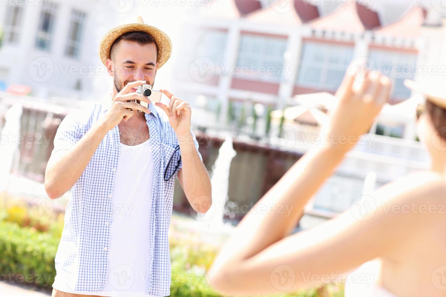 Man taking picture of his girlfriend photo