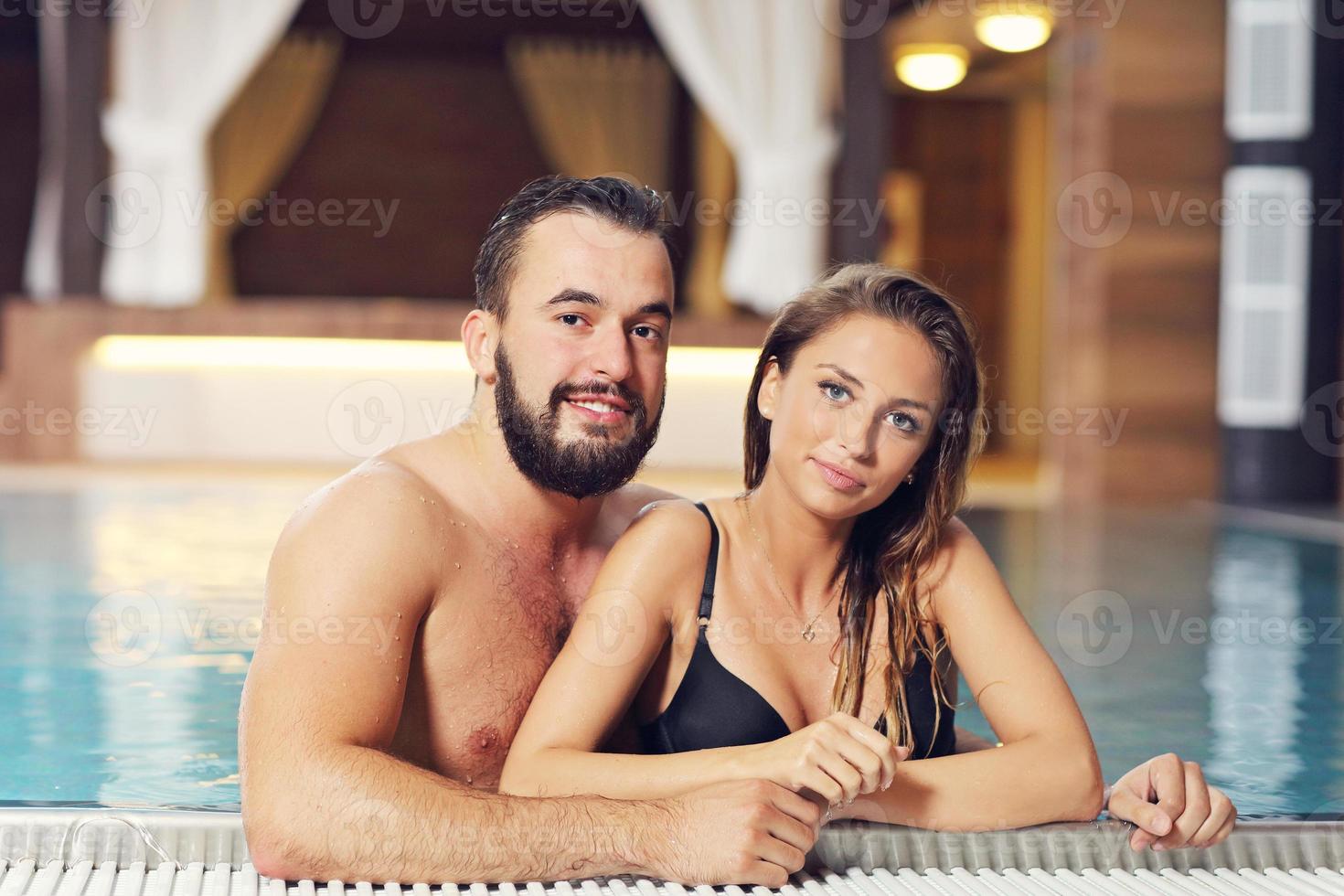 Happy couple relaxing in pool spa photo