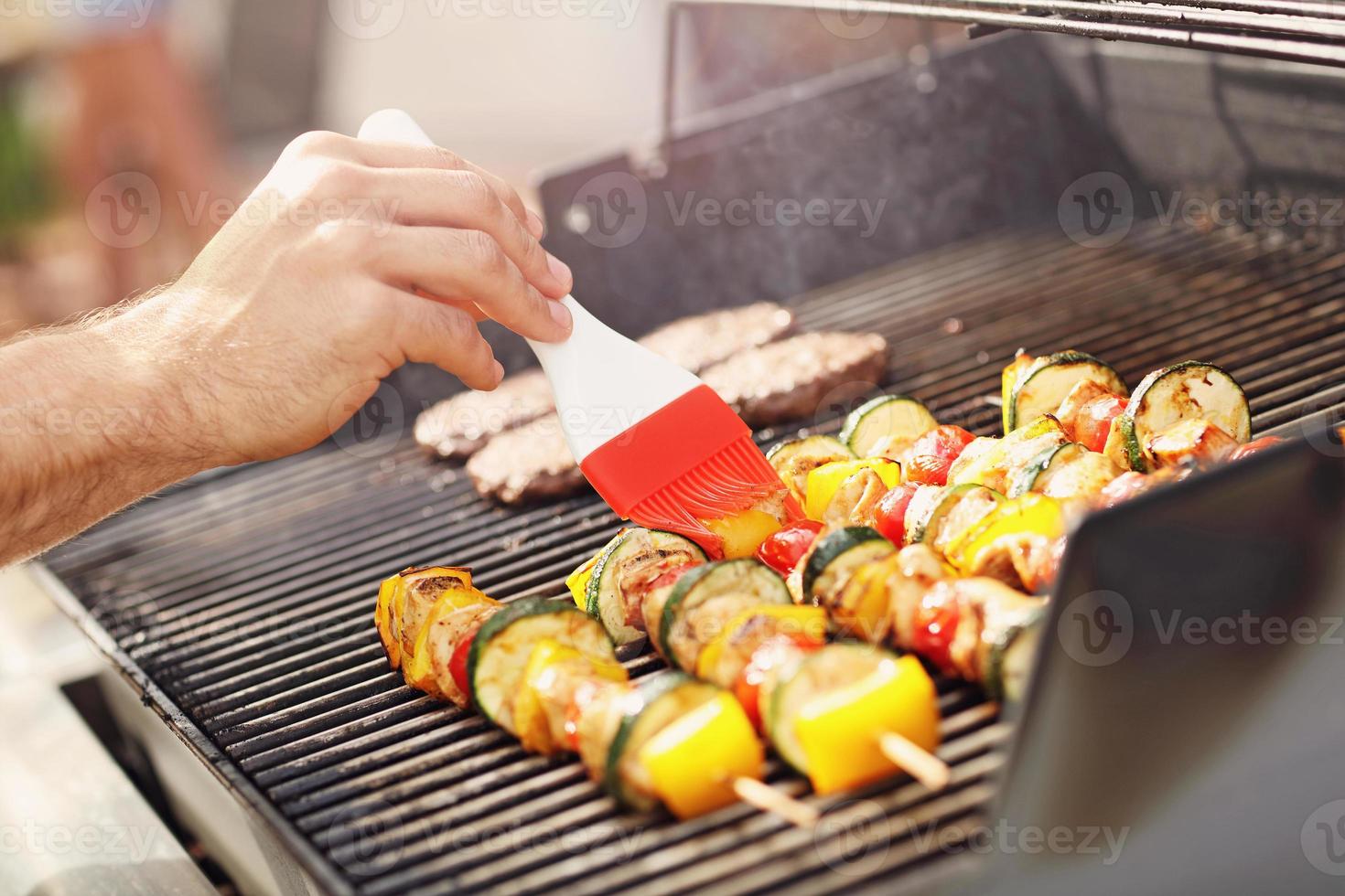 Grilled shashliks and hamburgers on grate photo