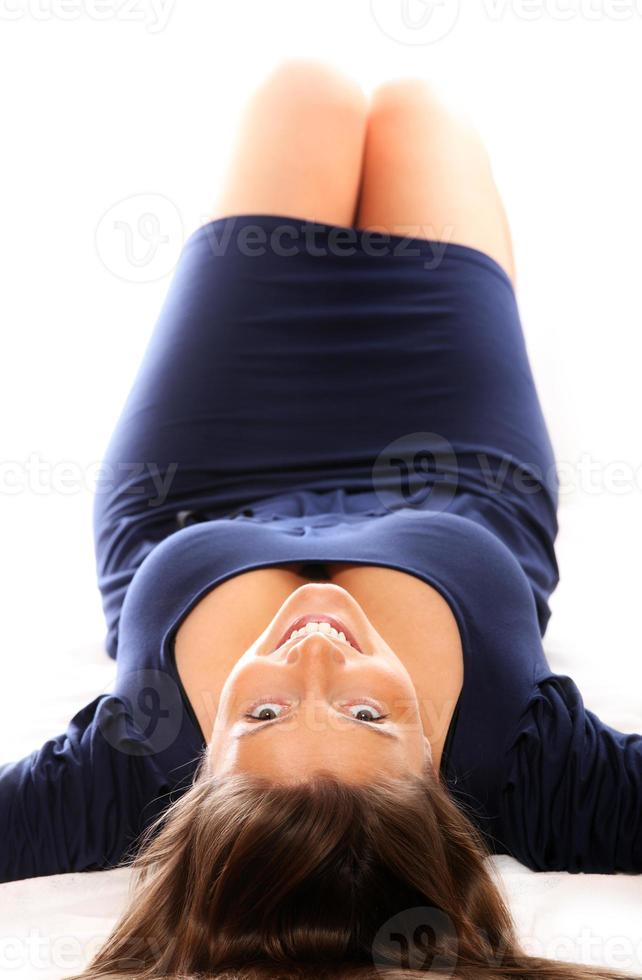 Pretty woman lying over white background photo