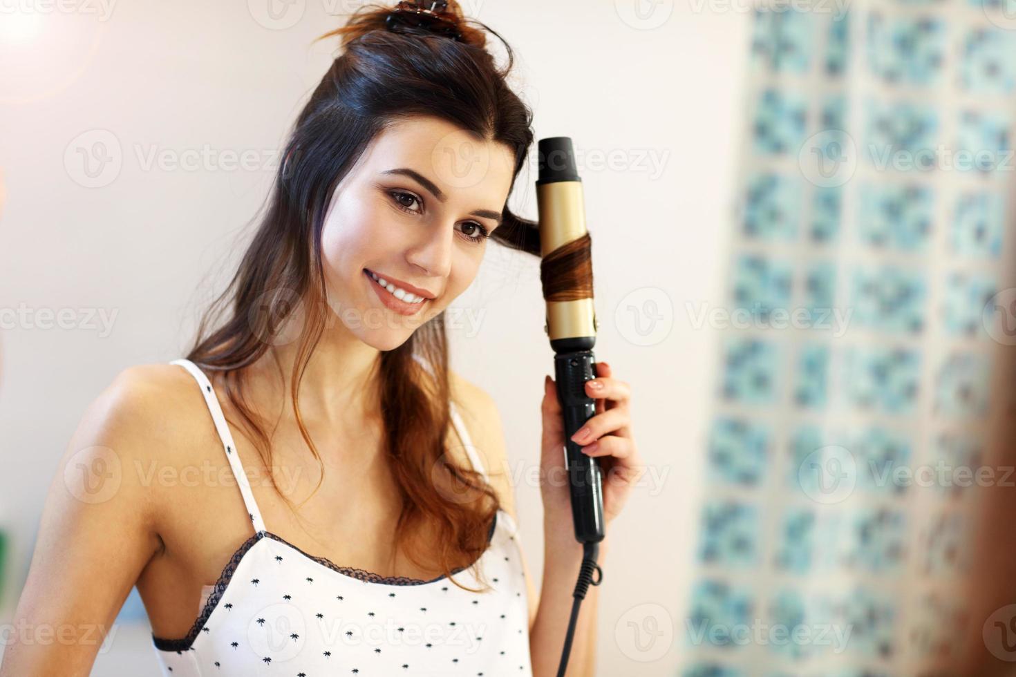 Young woman standing in bathroom in the morning photo