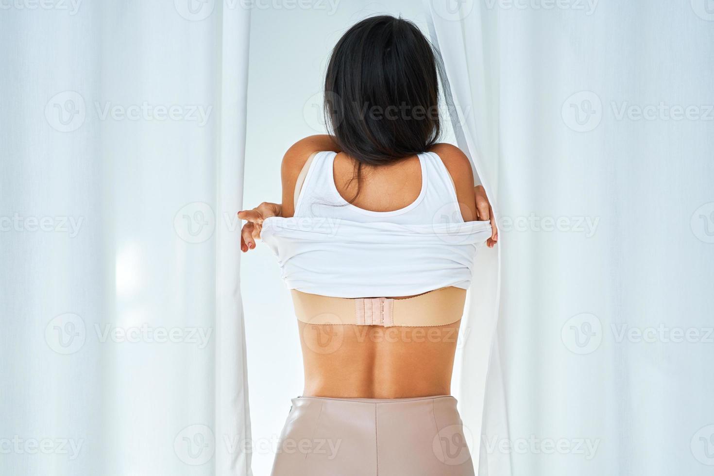 Woman in clothes store in changing room photo