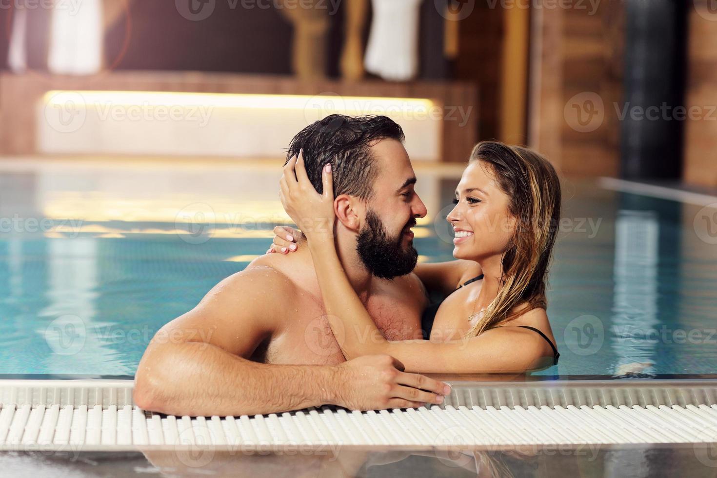 Happy couple relaxing in pool spa photo