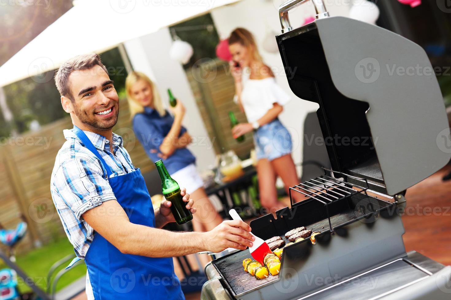 Group of friends having barbecue party photo