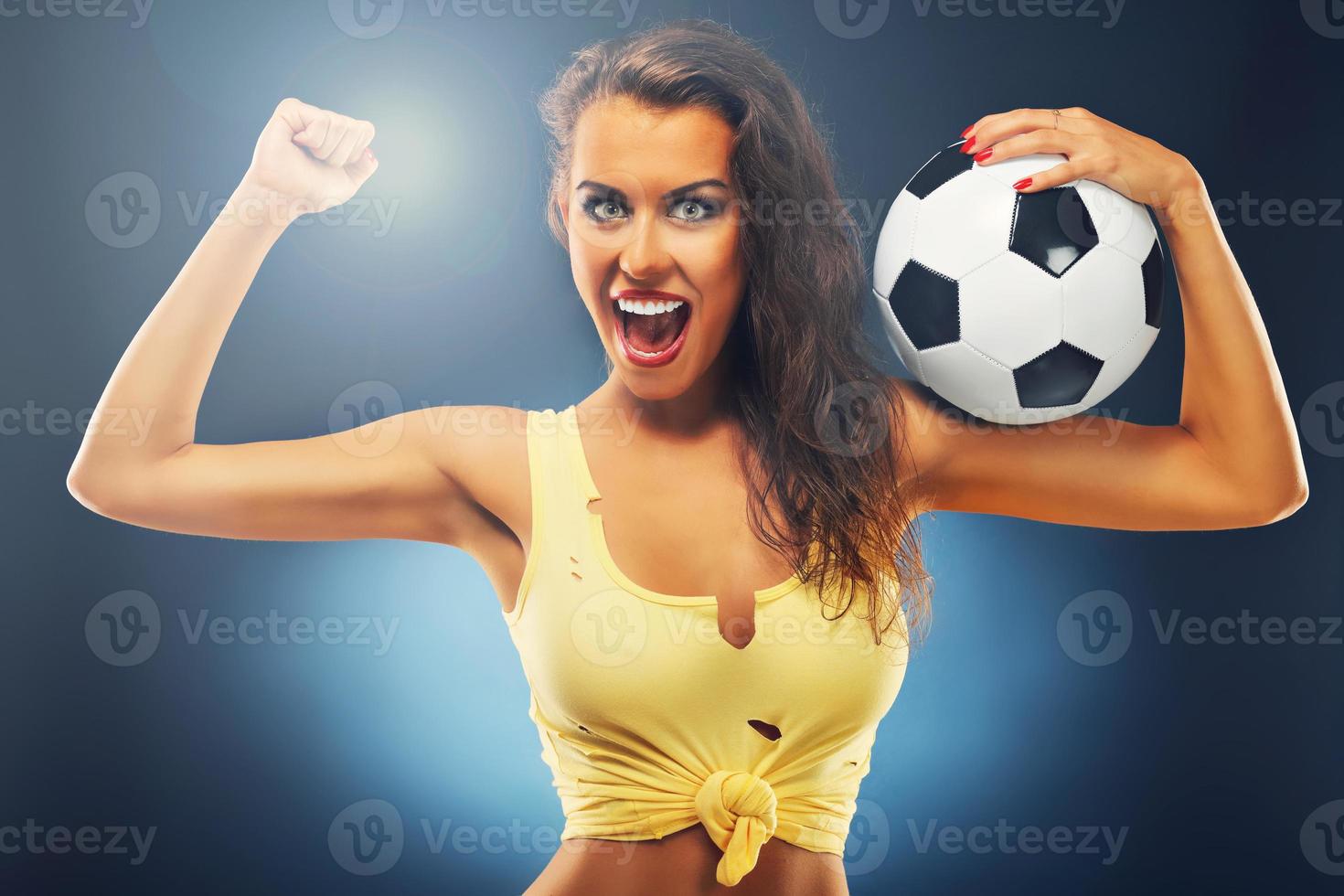 Happy fan cheering with football photo