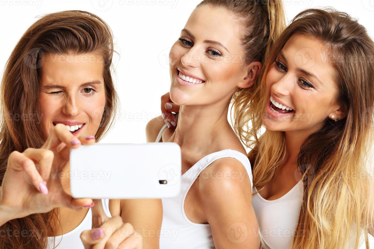 Group of happy friends taking selfie in underwear photo