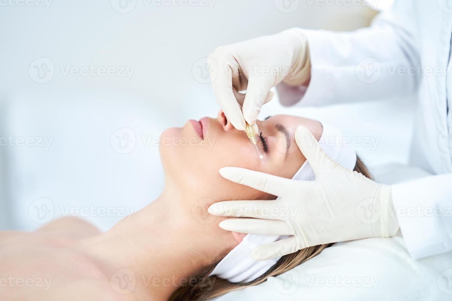 A scene of medical cosmetology treatments botox injection. photo