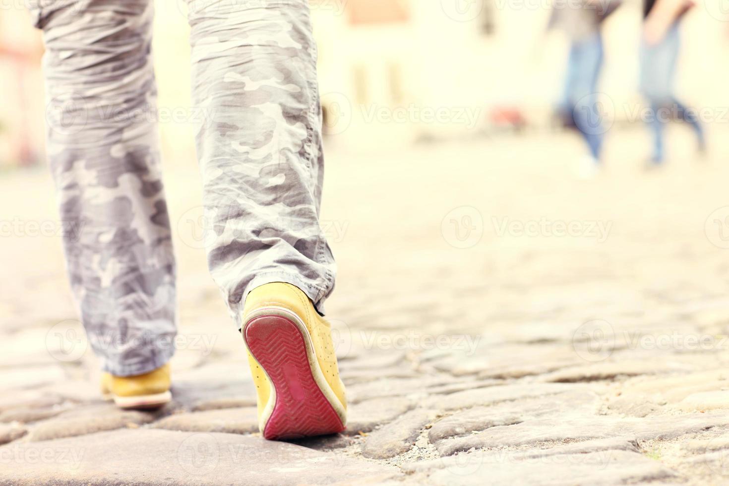 Female legs on paving blocks photo