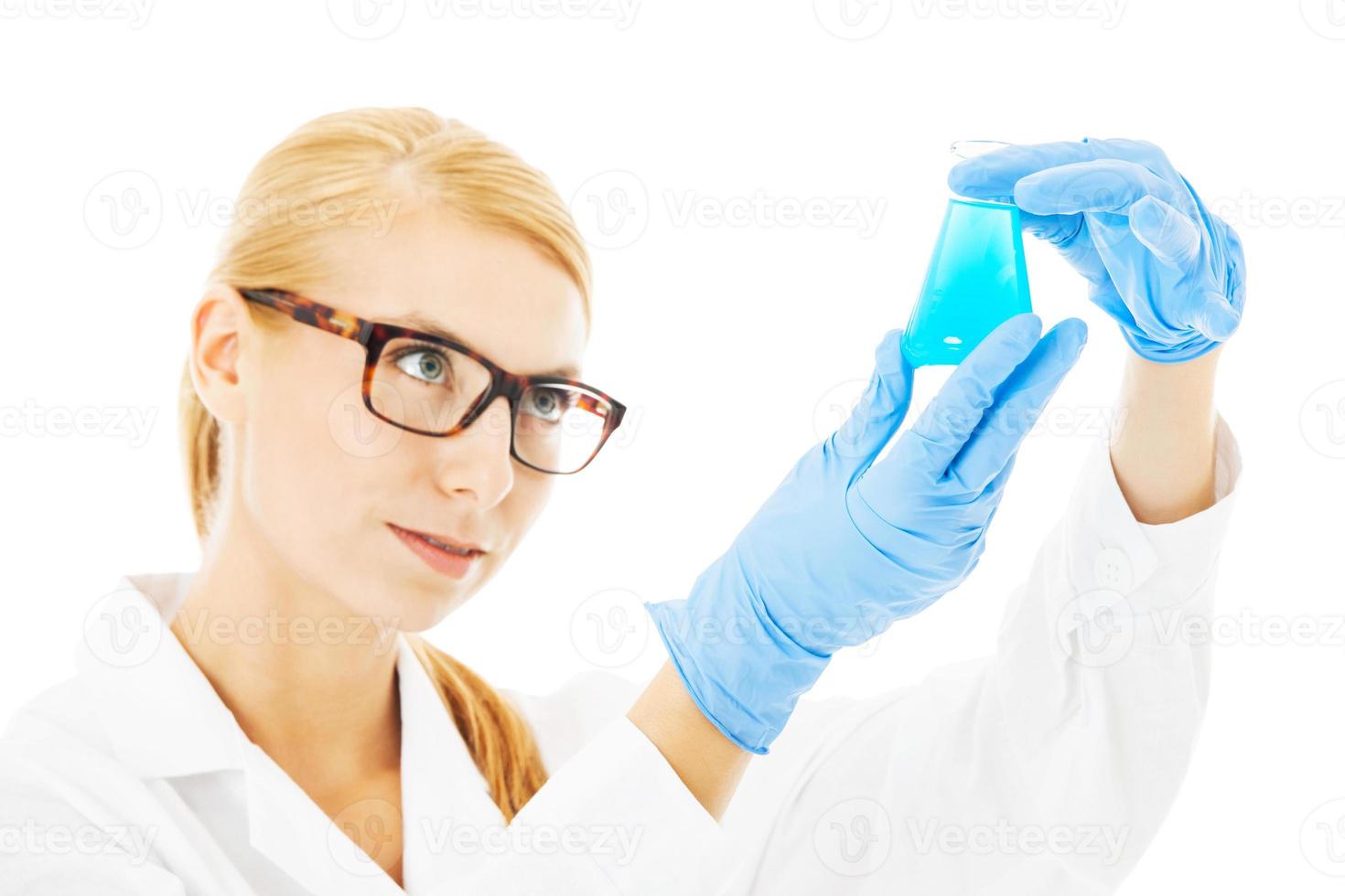 Scientist Examining Chemical In Beaker photo