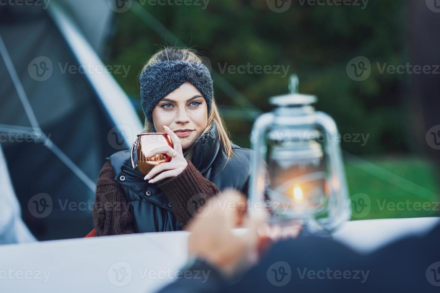 Young nice couple having fun on camping with kerosene lamp photo