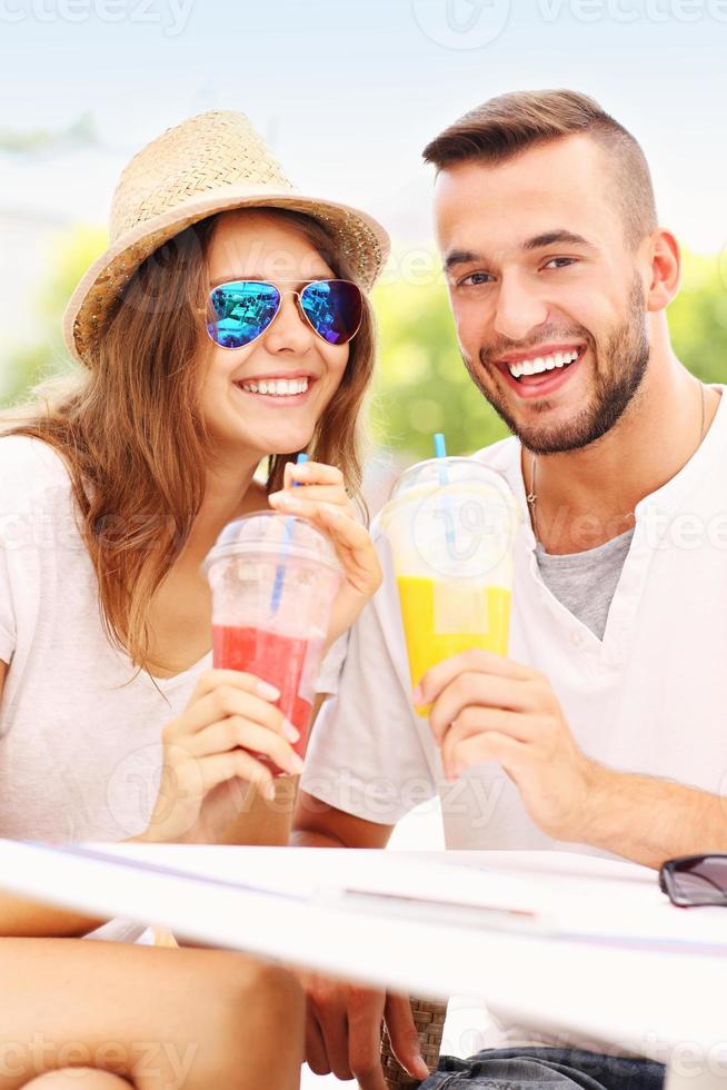 Joyful couple and smoothies in a cafe photo