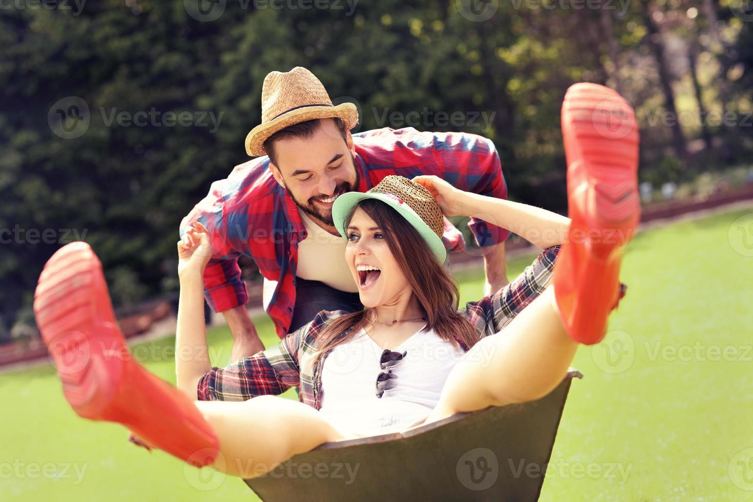 Young couple having fun in the barrow photo