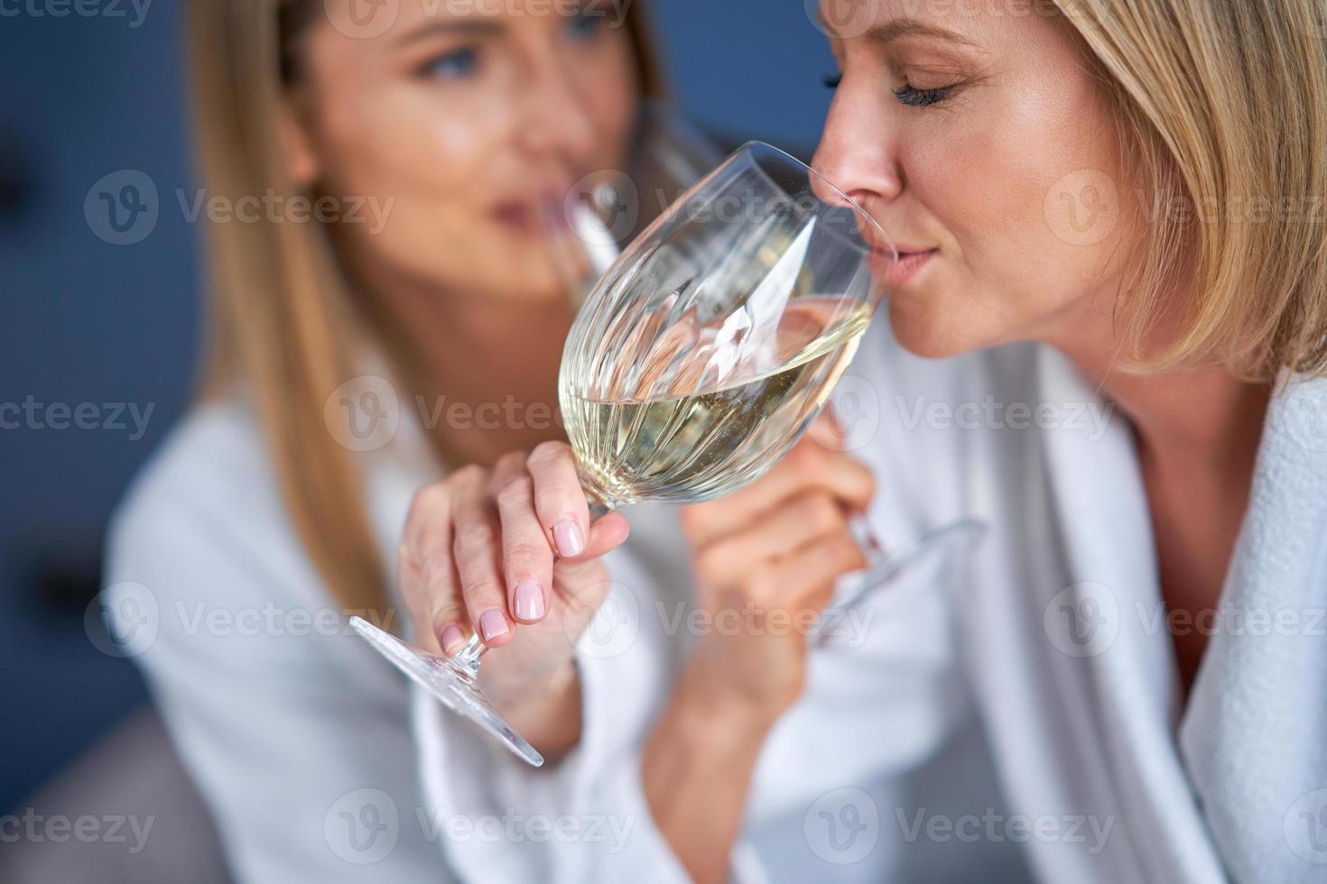 Two girl friends or couple in bedroom having fun photo