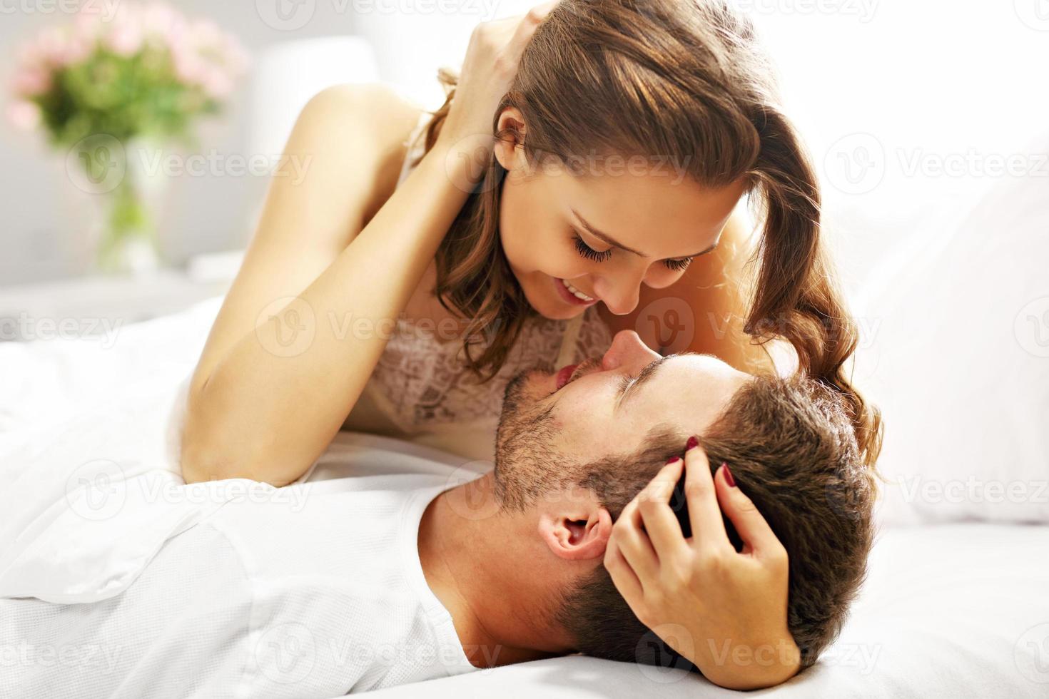 Young couple hugging in bed photo