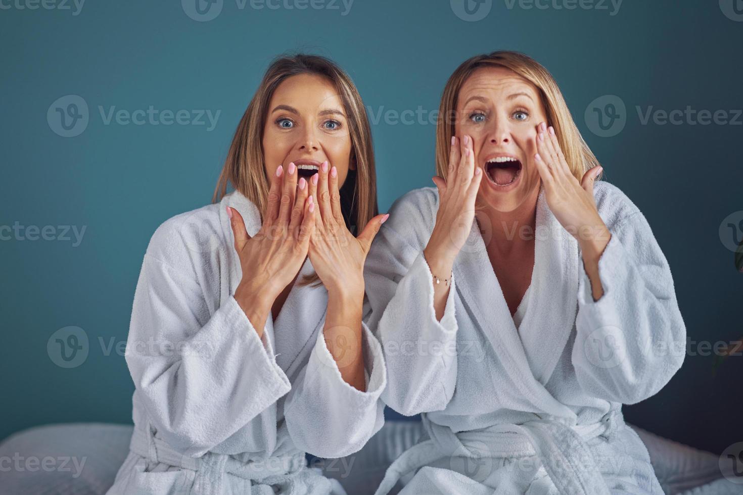 Two girl friends or couple in bedroom having fun photo