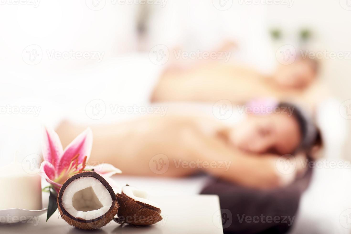 Two beautiful women getting massage in spa photo