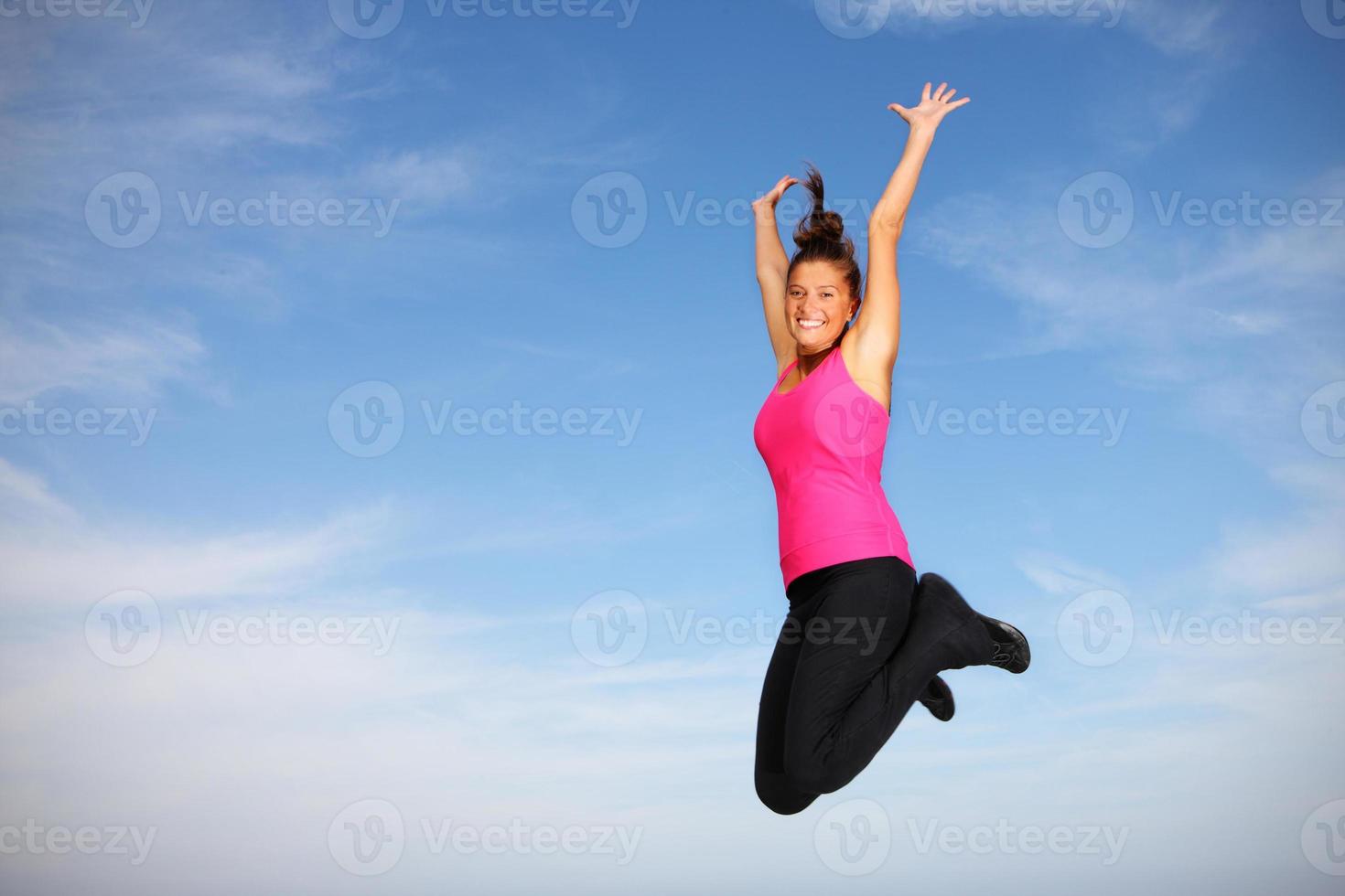 Pretty young woman jumping photo