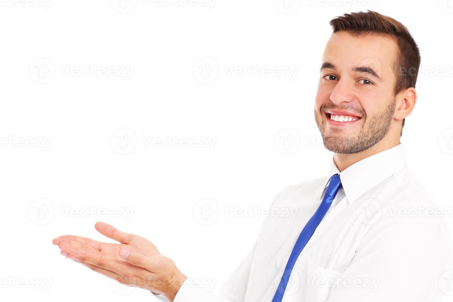 Happy businessman presenting something over white photo