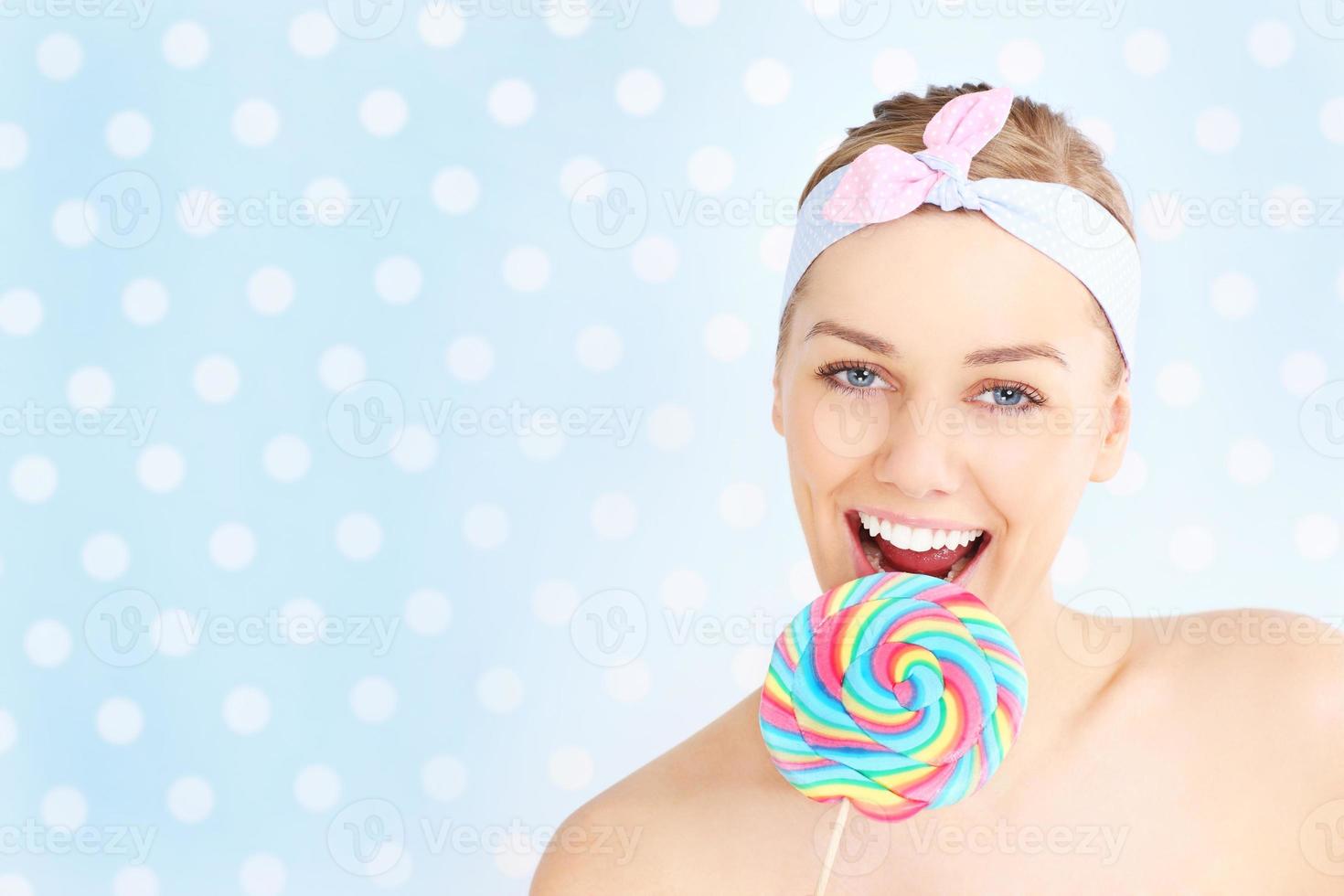 Retro woman with lollipop photo