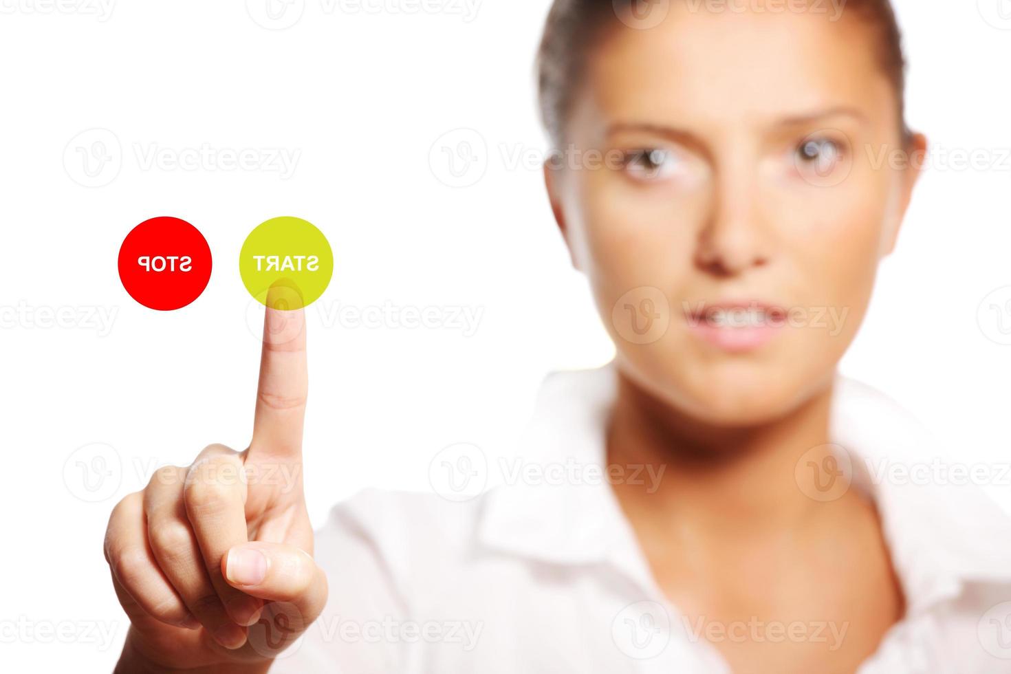 Young businesswoman touching the start button photo