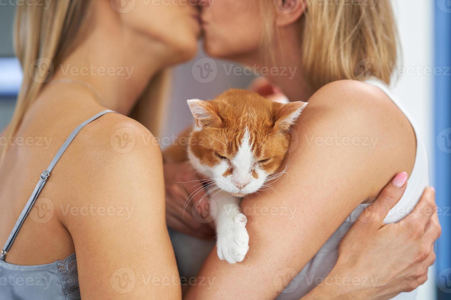 Nice two adult girls in the house with cat photo