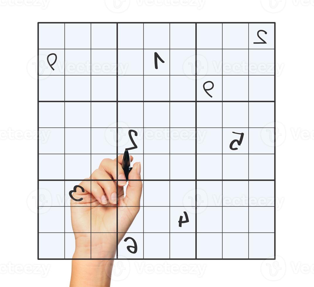 Hand playing sudoku photo