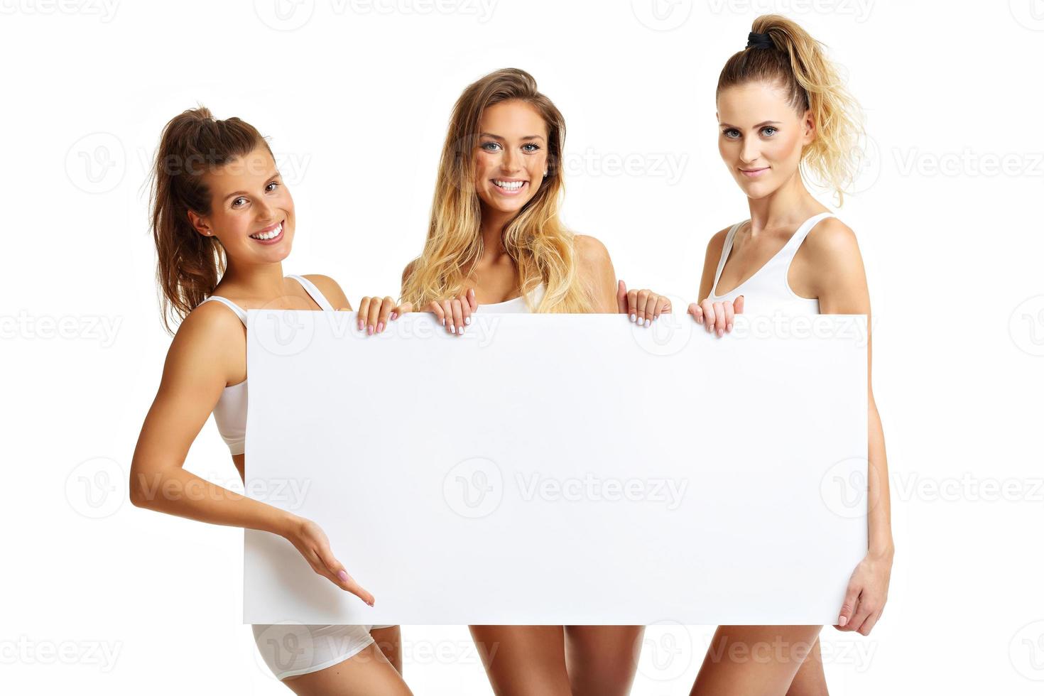 Group of happy friends posing in underwear with banner photo