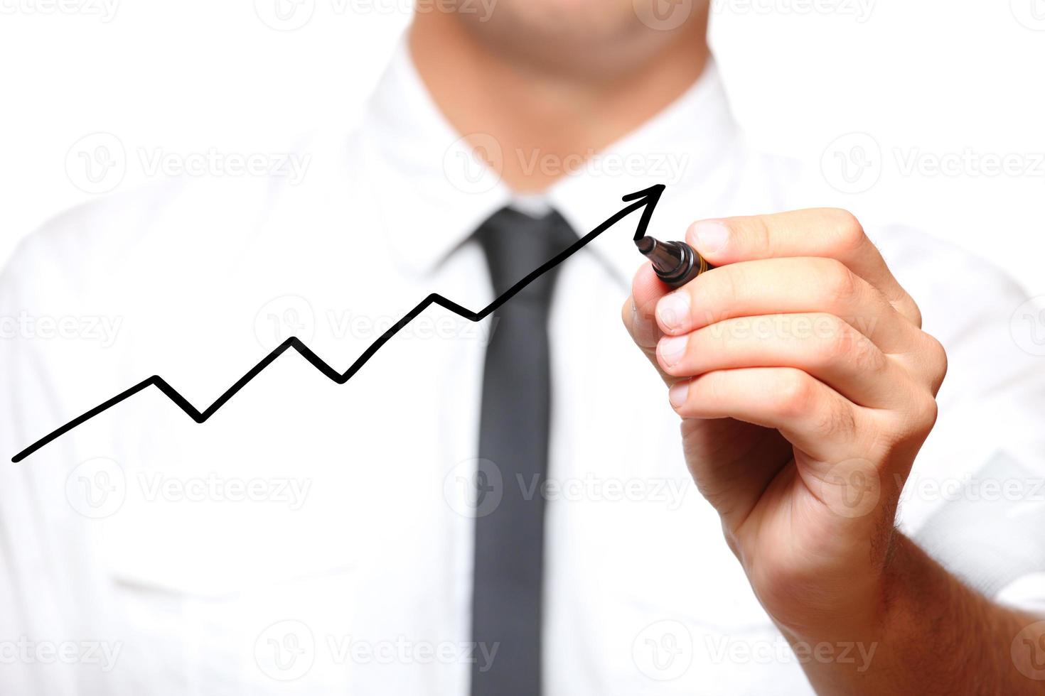 Businessman drawing an arrow going up photo