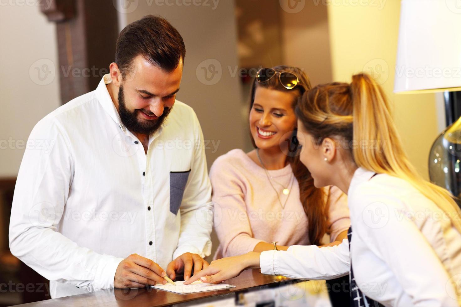 Man signing bill in hotel photo